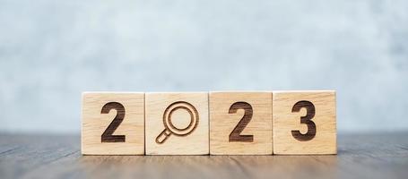 2023 block with magnifying glass icon. SEO, Search Engine Optimization, hiring , Advertising, Idea, Strategy, marketing, Keyword, Content and New Year start concepts photo