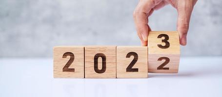 hand flip 2022 to 2023 block. goal, Resolution, strategy, plan,, motivation, reboot, forecast, change, countdown and New Year holiday concepts photo
