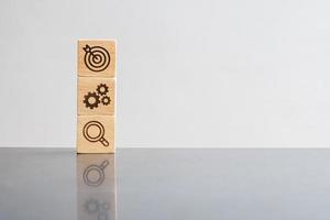 wood block with business goal, strategy, target, mission, action, objective, teamwork, brainstorm and idea concept photo