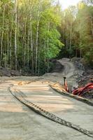 Construction of a modern ski-roller track on the forest slopes. photo