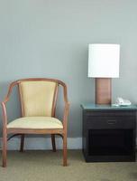 chair and table lamp in bedroom photo