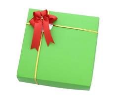 Green gift box with red ribbon bow isolated on white with clipping path photo