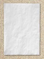 white crumpled paper on cork board background photo