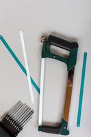 Top view of handle new hacksaw on gray backgroun. Working tool for carpenters. photo