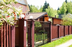 Gate, fence and spring nature. Colorful spring background, home entrance, curb appeal photo