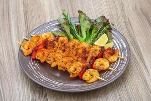 Prawn skewer on the plate and white background photo