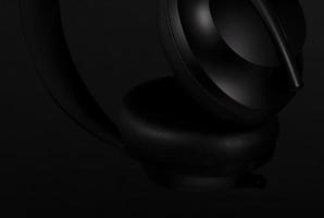 Close-up of black headphones on black background photo