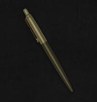 Premium quality golden Parker ballpoint pen on leather background photo