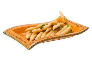 Baby corn in a bowl on white background photo