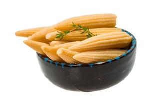 Baby corn in a bowl on white background photo