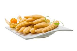 Baby corn in a bowl on white background photo