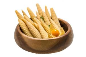 Baby corn in a bowl on white background photo