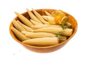 Baby corn in a bowl on white background photo