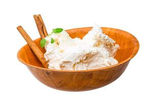 Cottage cheese in a bowl on white background photo