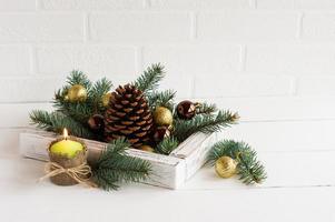 decor to celebrate the new year and Christmas. wooden box with colorful balls and cedar cone. photo