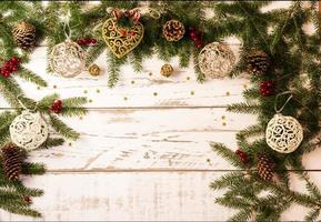 Christmas or New Year's background with green branches of spruce, cones, gold toys, openwork balls. A copy of the space for your text. photo