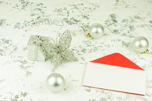 layout of an empty envelope for your text on a New Year's festive background with silver balls, a box and an openwork butterfly. photo