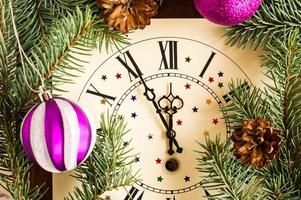 Countdown to midnight. retro watches with spruce branches, cones and Christmas balls. happy new concept of the year. photo