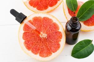 top view of juicy grapefruit with grapefruit cosmetic oil pipette. rejuvenating serum.skin care. photo