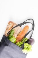 Eco-friendly shopping bag filled with organic vegetables, buckwheat flour paste, gluten-free bread. the concept of buying the right food. photo