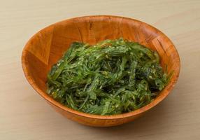 Chuka salad in a bowl on wooden background photo