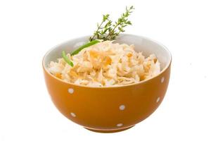 Fermented Cabbage in a bowl on white background photo