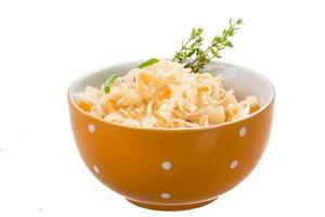 Fermented Cabbage in a bowl on white background photo