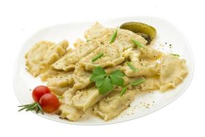 Potato dumplings on the plate and white background photo