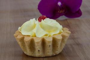 Creamy basket on wooden background photo