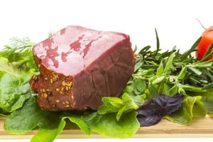 Smoked beef on wooden board and white background photo