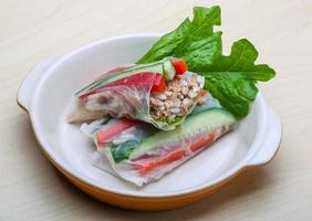 Spring rolls in a bowl on wooden background photo