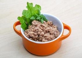 Canned tuna in a bowl on wooden background photo