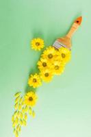Brush pattern with yellow flowers on a green background. floral painting and creative decoration. vertical background. photo