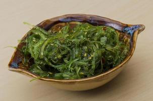 Chuka salad in a bowl on wooden background photo