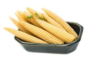 Baby corn in a bowl on white background photo