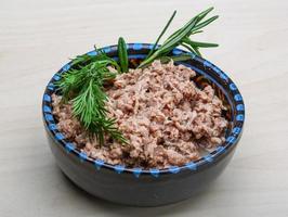 Cannded runa in a bowl on wooden background photo