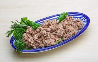 Cannded runa in a bowl on wooden background photo