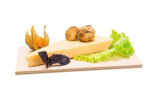 Parmesan cheese on wooden board and white background photo