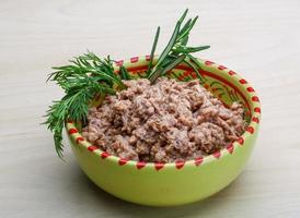 Cannded runa in a bowl on wooden background photo