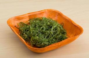 Chuka salad in a bowl on wooden background photo