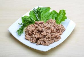 Cannded runa on the plate and wooden background photo