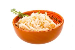 Fermented Cabbage in a bowl on white background photo