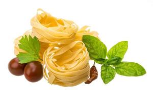 Raw tagliatelle on white background photo