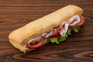 Ham sandwich on wooden background photo