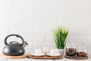 stylish kitchen background with items for coffee ceremony. environmentally items on the countertop against the white brick wall. a copy of the space. photo