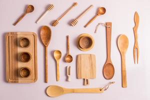 top view of a set of different wooden and bamboo kitchen utensils. flat layout. eco-friendly cutlery. zero waste. photo