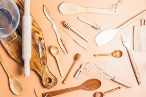 a collection of various kitchen utensils for cooking on a brown background. top view. flat styling. environmentally friendly items.