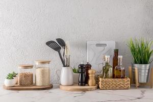 a wide range of kitchen utensils on a marble white countertop. kitchen modern background. eco-friendly materials without plastic. photo