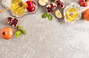 festive background of New Year Rosh Hashanah. top view. flat sunbed. pomegranates, apples, honey in a silver bowl. photo