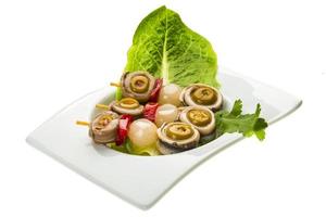 Anchovy rolls in a bowl on white background photo